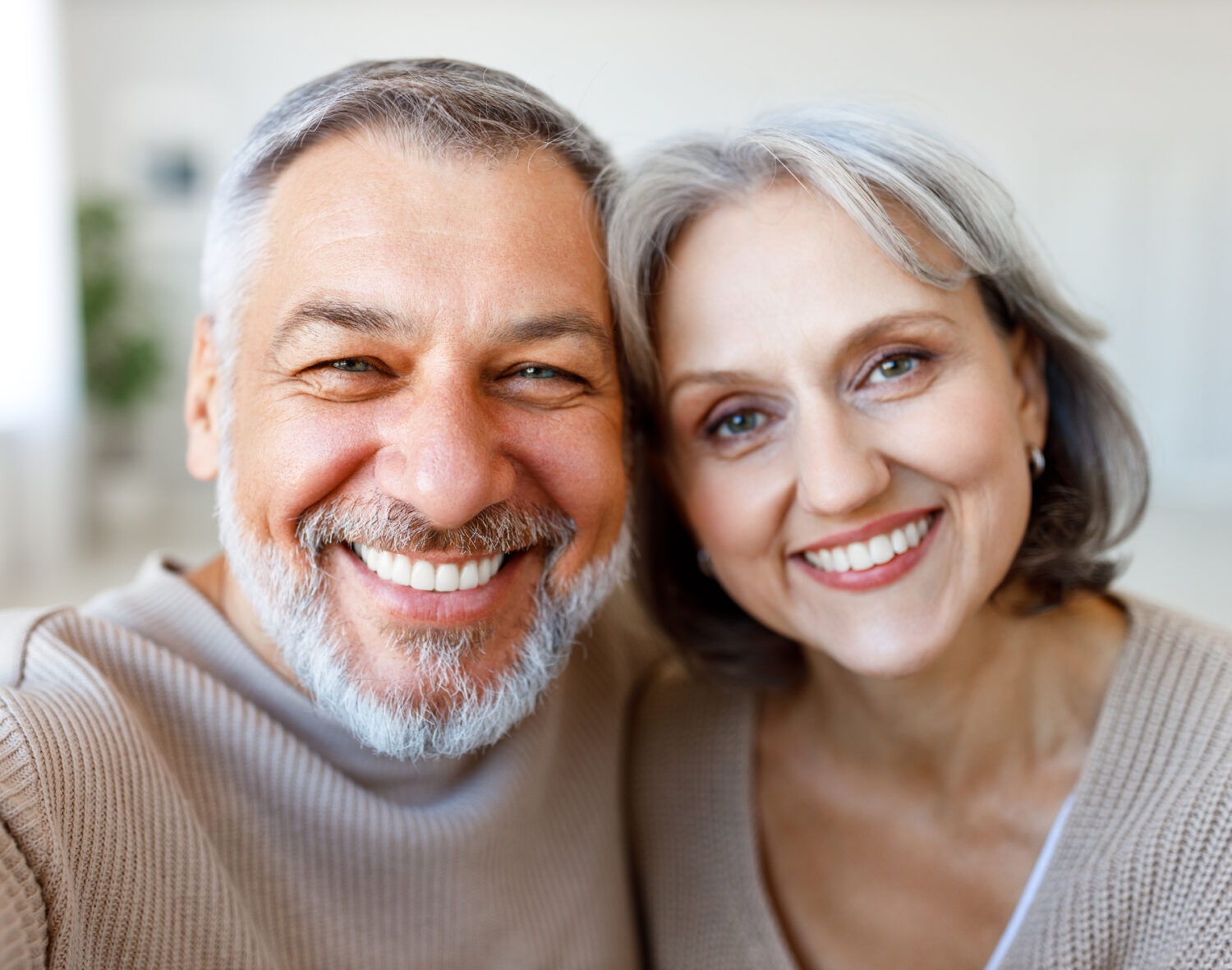 Portrait of happy beautiful senior caucasian family couple smiling at camera, cheerful
