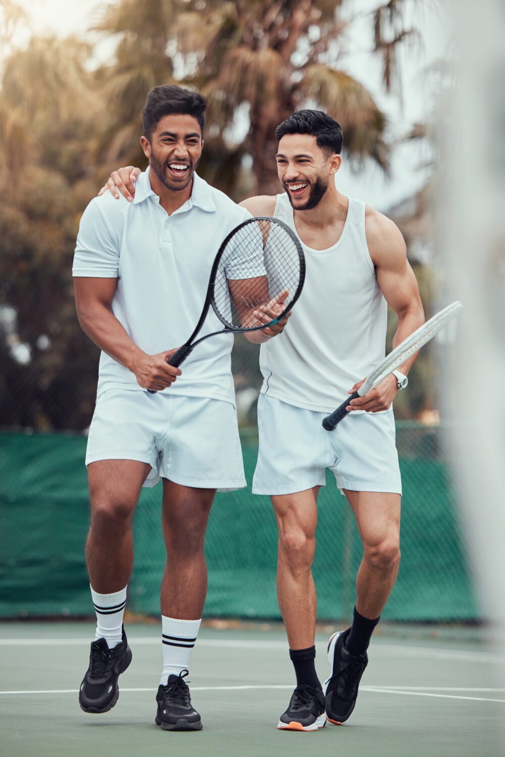 Two young men playing tennis