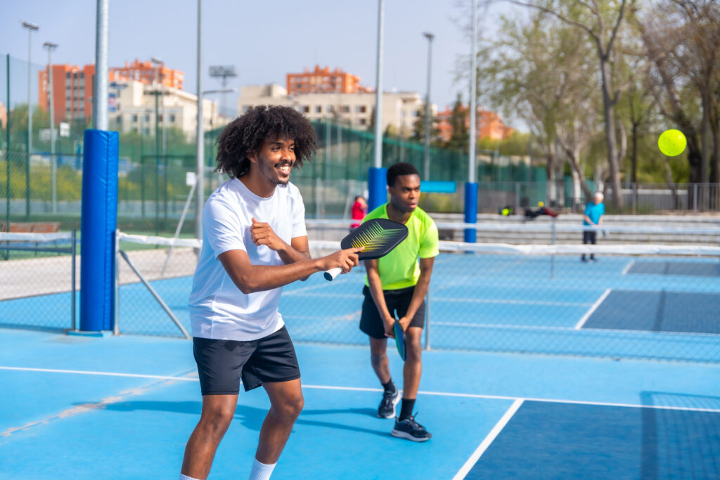 Two males playing friendly pickleball