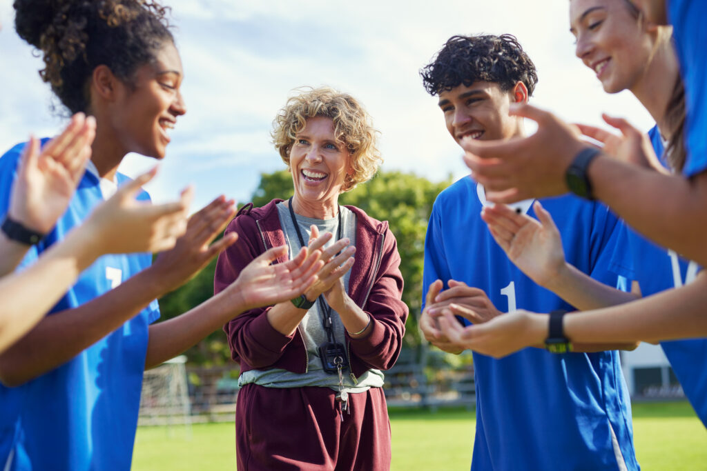 Female coach encourages sports team