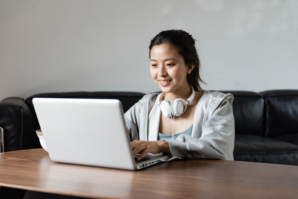 A young Asian woman using a computer for assesments