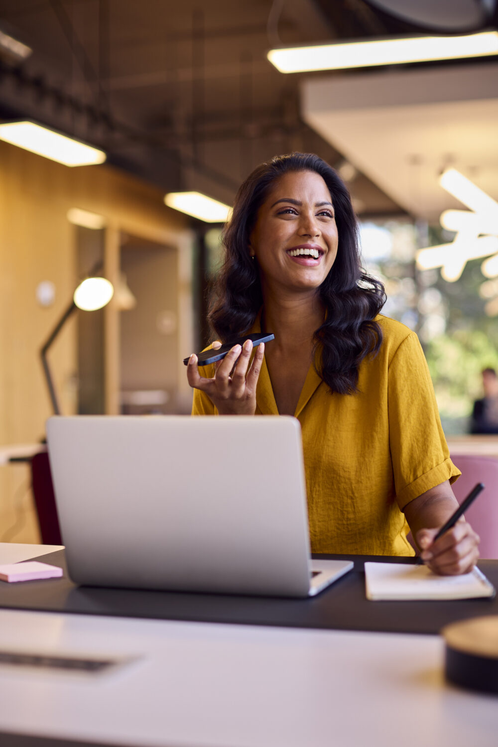 Mature woman working at desk with a lot of tasks to manage